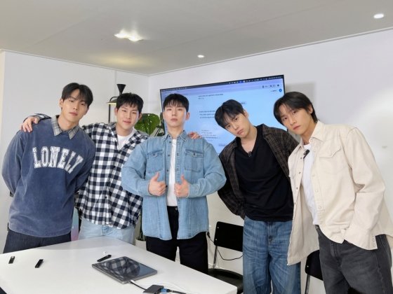 MONSTA X members laugh during the ChatGPT segment. Image © MONSTA X YouTube Channel