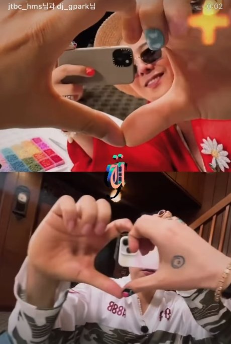 G-Dragon and Park Myung Soo create a hand heart on set. Photo: G-Dragon